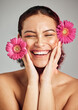 © K. A./peopleimages.com - Natural beauty, flowers and face of happy woman with eco friendly makeup, facial product or floral skincare glow. Sustainable cosmetics, spa salon girl and model smile isolated on studio background