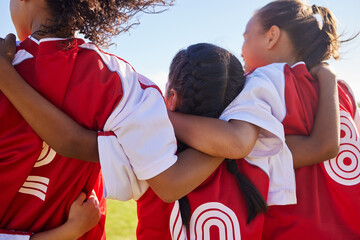 Wall Mural - Girl, soccer group and back with huddle on field for match, contest or game with team building support. Female kids, football player children and hug for solidarity, diversity or motivation on pitch