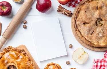 blank cooking book cover mockup with apple pie, meat pie and seasonal fruit