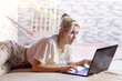 © 2Design - Serious woman working at home behind laptop in the morning