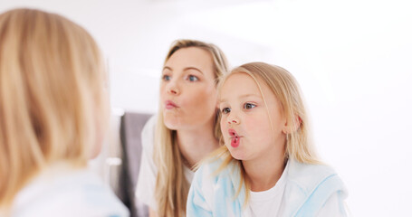 Happy, funny faces and mother with a child looking in the mirror while making a comic joke. Happiness, smile and young mom having comedy fun with her daughter at their family home in Australia.