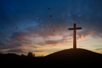 Wall Mural - cross on blurry sunset background 