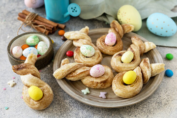 Wall Mural - Easter bake idea. Easter rabbit-shaped buns puff pastry with  cinnamon on a stone tabletop.