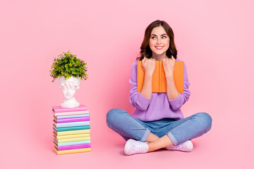 Sticker - Full length photo of dreamy funny lady wear violet sweater looking empty space enjoying book pile isolated pink color background