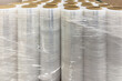 © AGSOL - Roll of industrial packaging film. Stretch film in rolls stands in a row. The use of film as a packaging material. Place for text with copy space.