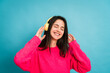 Smiling woman in headphones and listening music