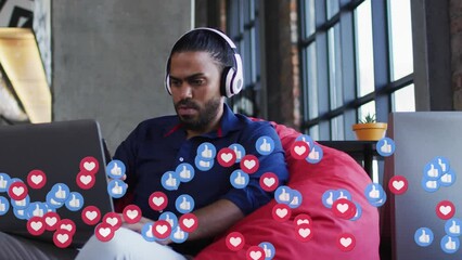 Poster - Animation of social media emoji icons over biracial businessman using laptop