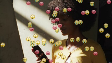 Poster - Animation of social media emoji icons over african american woman using smartphone