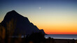 Mountain above the sea at sunset with moon 