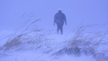 Woman Falls From Exhaustion To Her Knees During A Snowstorm. Stable Medium Shot