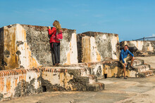 A Young Woman Enjoys An Historic Fort On The Edge Of The Atlantic Ocean From Old San Juan, Puerto Rico.