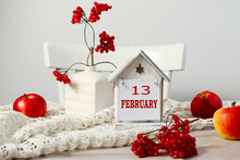  Calendar For February 13: The Name Of The Month February In English, The Numbers 13 On A Decorative House Among The Branches Of Viburnum, Red Apples On A White Napkin