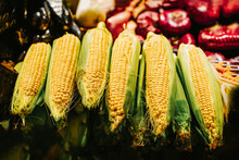 Several Ripe Yellow Corn Cobs Close-up On Display At Farmers Market