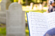 Hymnal with gravestones in background