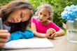 © Cavan Images - Little girl looking at sister drawing map, Chilliwack, British Columbia, Canada