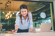 © photobyphotoboy - Asian business woman working using  laptop for do math finance on wooden desk, tax, accounting, statistics and analytical research concept