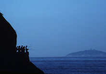 Fishermen Crowded On Cliff.