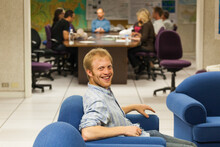 A Man Relaxes In A Seminar Room With Other Scientists At A Research Institute In Boulder, Colorado.