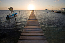 Sunrise Over A Wooden Pier On Caye Caulker, Belize