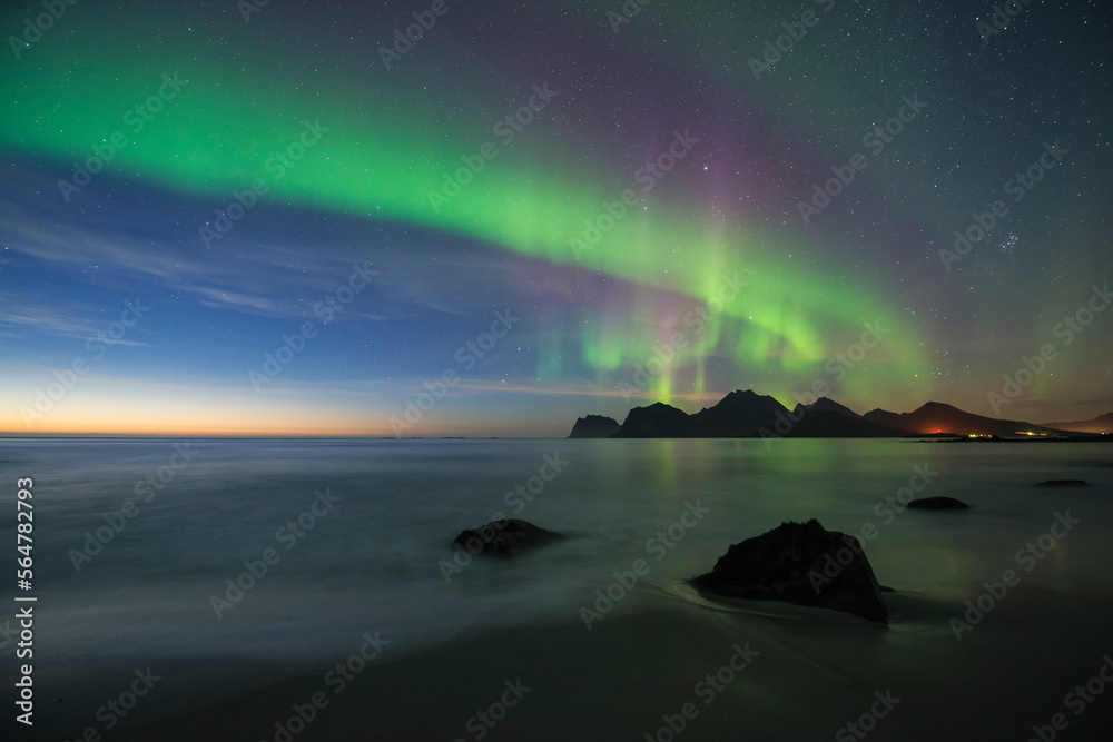 Northern Lights - Aurora Borealis shine in sky over sea and mountains ...
