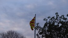 Catalonian Flag Flapping In The Wind On Montjuïc With A Patchy Sky Behind (4K)