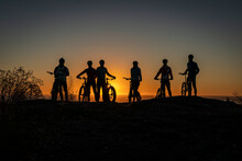 Group Of Mountain Bikers At Sunrise