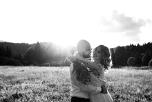 Portrait In Black And White Shows A Happy Couple Hugging