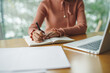 © Marc Tran/Stocksy - Cropped image of professional businesswoman working at her office