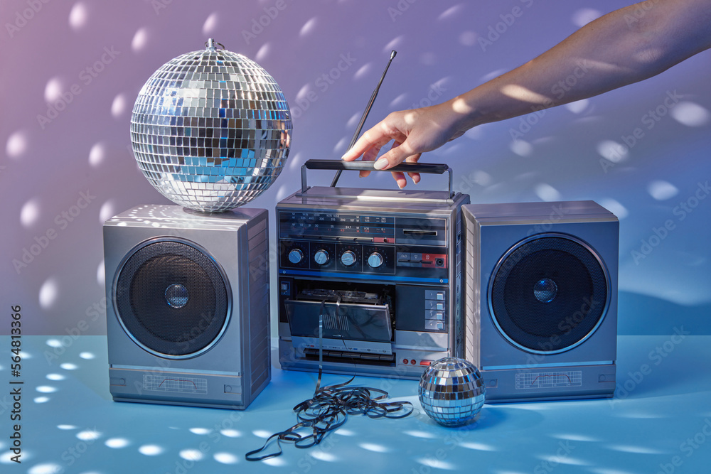 90s music stereo system held by woman's hand.
