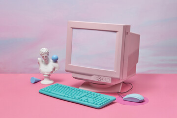 Retro PC and antique statue.
