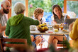 © Guille Faingold/Stocksy - Multiracial family having weekend breakfast