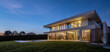 © Nibuya Qubik/Stocksy - Modern residential cozy family house with the interior illuminated