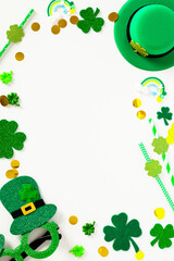 Wall Mural - St Patrick's Day vertical banner template. Frame made of Saint Patricks Day party decorations, leprechauns hat, glasses, shamrock on white background. St Patrick's Day party invitation design.