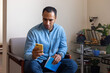 © Demetr White/Stocksy - man in chair looking at phone