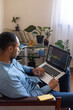 © Demetr White/Stocksy - a man follows the crypto market online