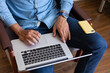 © Demetr White/Stocksy - Hands of a man typing on a laptop keyboard