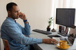 © Demetr White/Stocksy - male trader talking on the phone behind a laptop