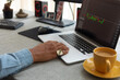 © Demetr White/Stocksy - a man's hand with a ring on a laptop, in the frame a mug of coffee