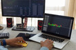 © Demetr White/Stocksy - trader's hands at work