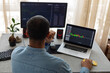 © Demetr White/Stocksy - man behind two monitors