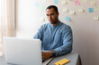 © Demetr White/Stocksy - serious man working on a laptop