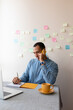 © Demetr White/Stocksy - man talking on the phone and taking notes