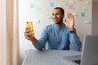 © Demetr White/Stocksy - man taking a selfie at the table