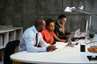 © BONNINSTUDIO/Stocksy - Diverse colleagues talking together in office