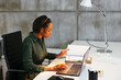 © BONNINSTUDIO/Stocksy - Focused woman working on laptop