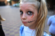 A Tween Girl Is Dressed Up As A Creepy Doll For Halloween