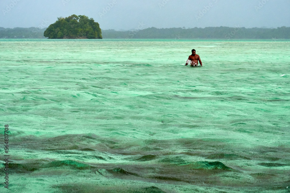 Pacific Islander man half-naked in ocean waters - Sea level rise Stock
