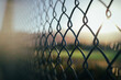 © Monica Murphy/Stocksy - Sunset through the fence