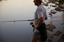 Man Fishing At Dusk