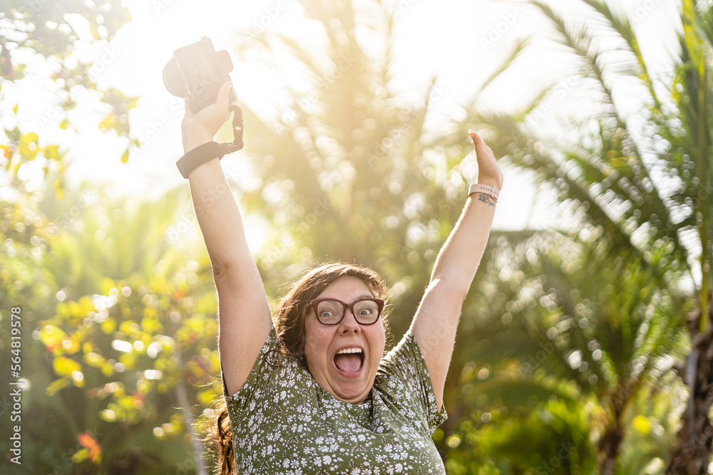 happy woman with her hands up on the beach Stock Photo | Adobe Stock